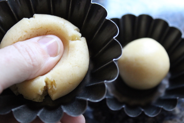 https://adamantkitchen.com/wp-content/uploads/2018/12/Pressing-Sandbakkel-Dough-into-Tins.jpg