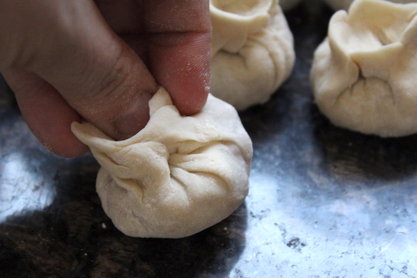 Shaping Buuz dumplings