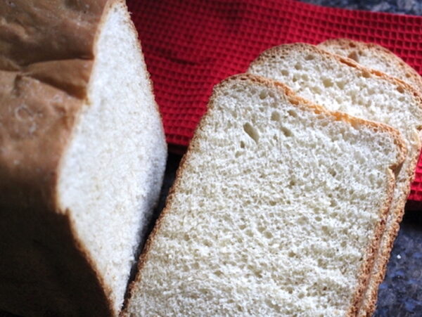 Bread machine white bread loaf with soft golden crust and fluffy white sandwich crumb