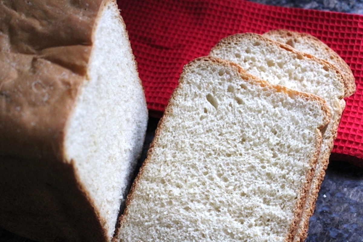 Bread machine white bread loaf with soft golden crust and fluffy white sandwich crumb