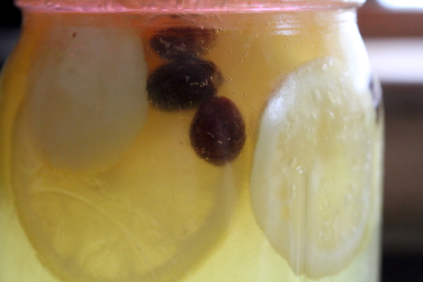 Raisins floating in a finished batch of lemon soda