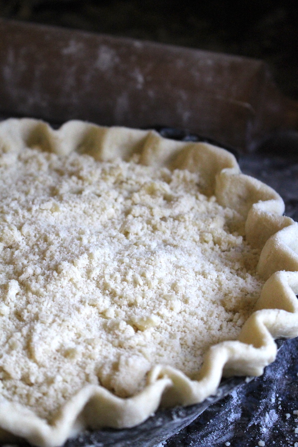 A rhubarb custard pie with crumb topping ready to be baked.