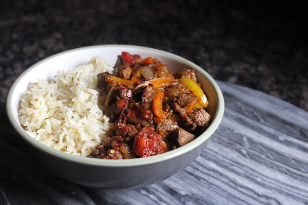 Homemade saç kavurma served with rice.