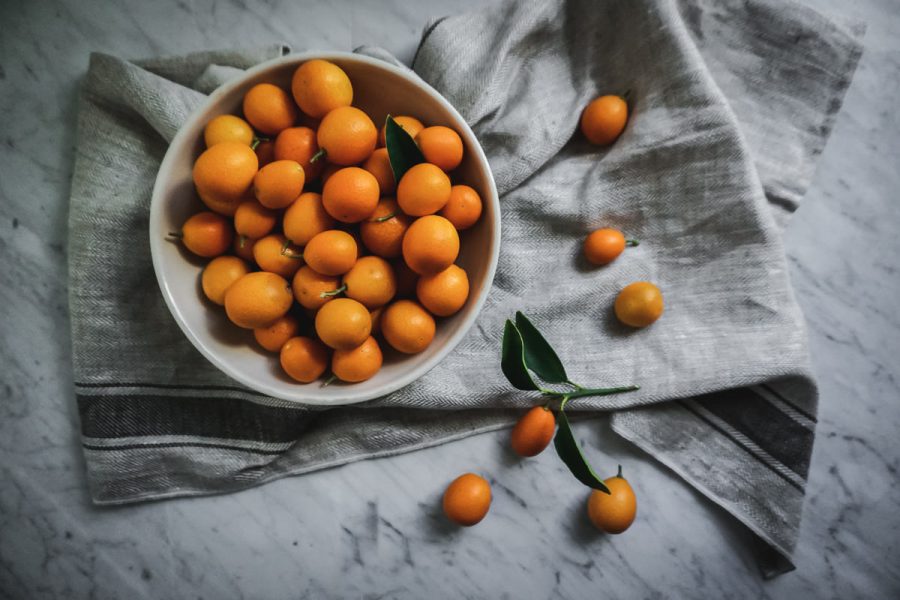 overhead view of a bowl filled with kumquats