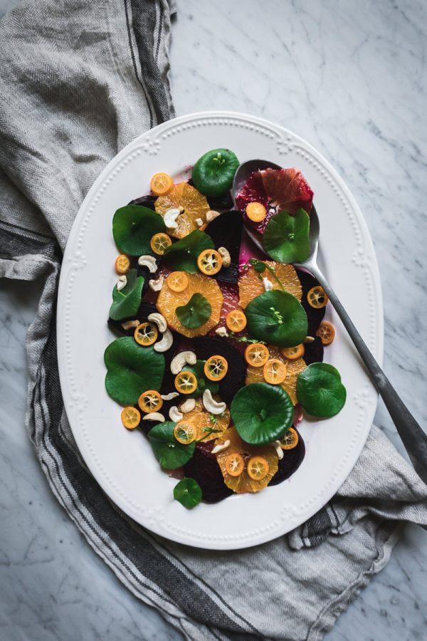 Platter of fresh spring salad made of foraged greens, beets and citrus.