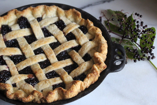 homemade elderberry pie baked with a lattice top pie crust