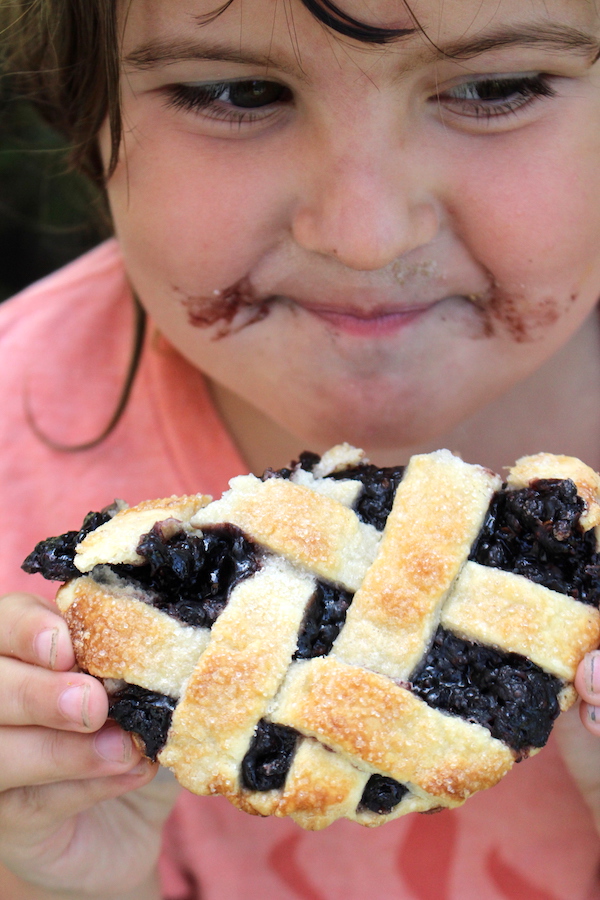 Child eating a pie made from dried elderberries