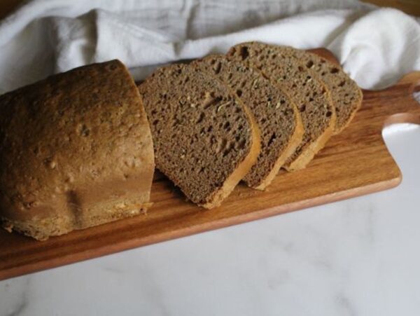 Bread machine zucchini bread loaf with golden crust and moist tender spiced quick bread crumb