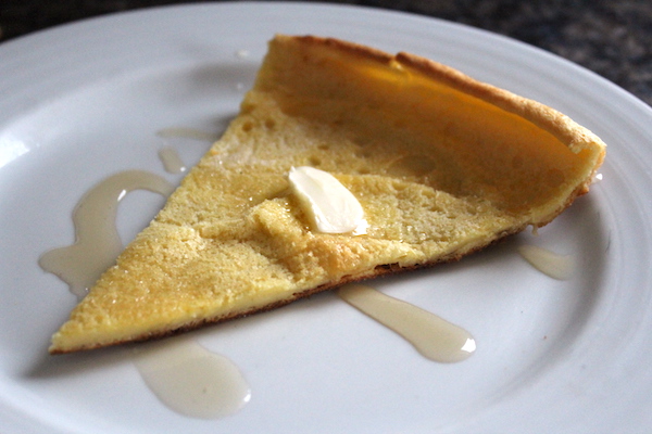 Slice of dutch baby pancake on a plate