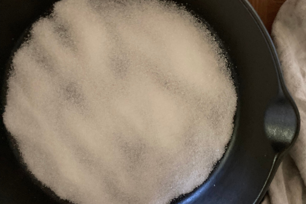 Sugar evenly distributed in pan ready to be melted
