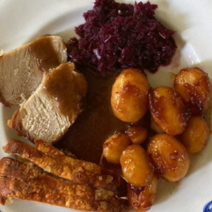 Flæskesteg served with rødkål, brown sauce, brunede kartofler and cracklings