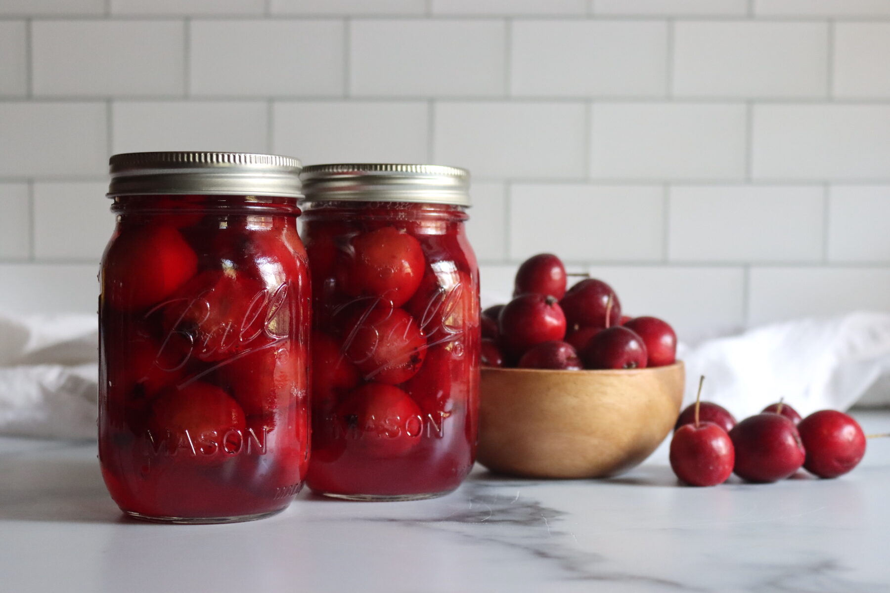 Jars of whole crabapples canned in light syrup